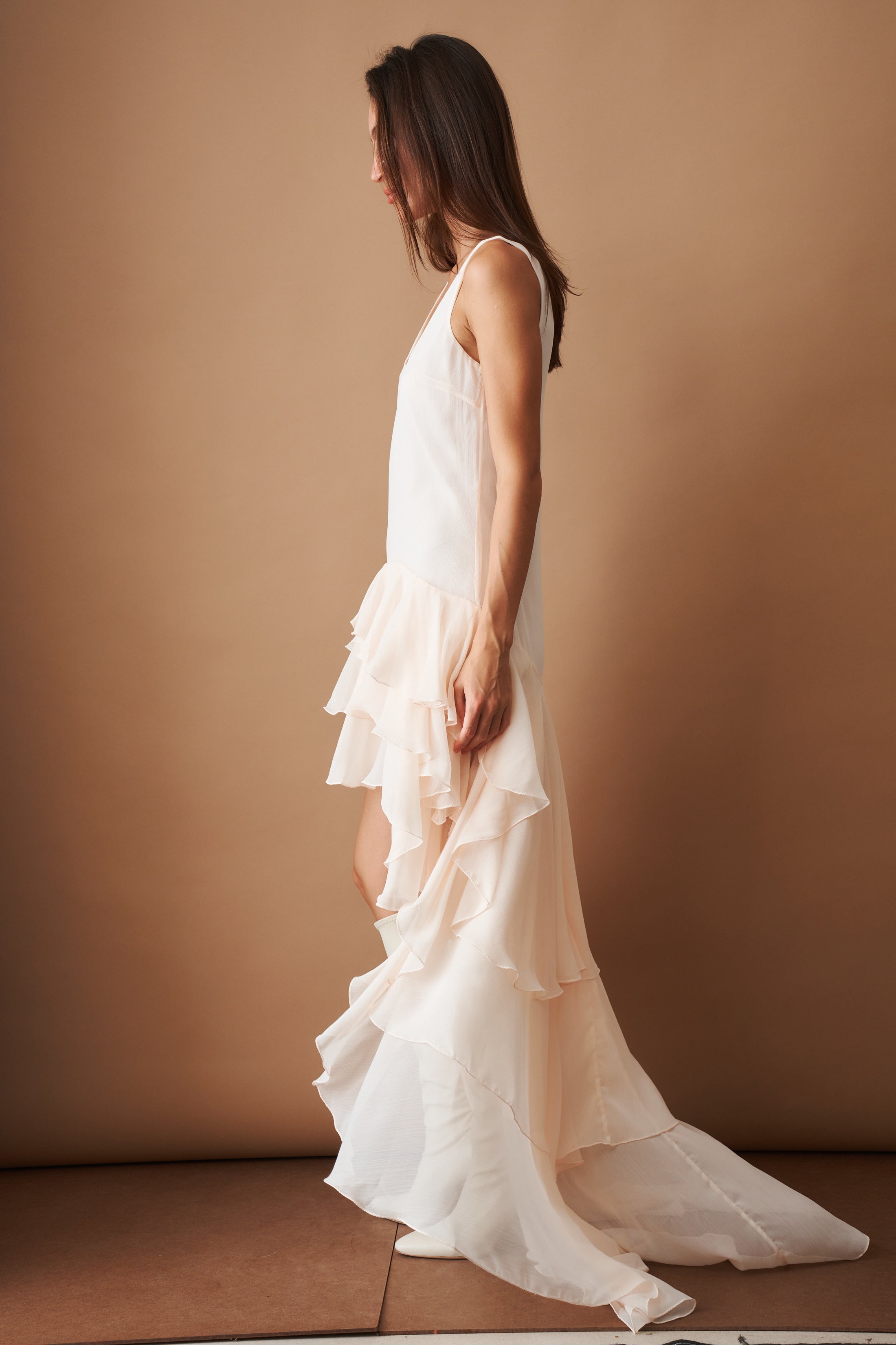 Light blue chiffon ruffle dress by ROTATE, flowing fabric with layered ruffle details, sleeveless design, perfect for summer wear.