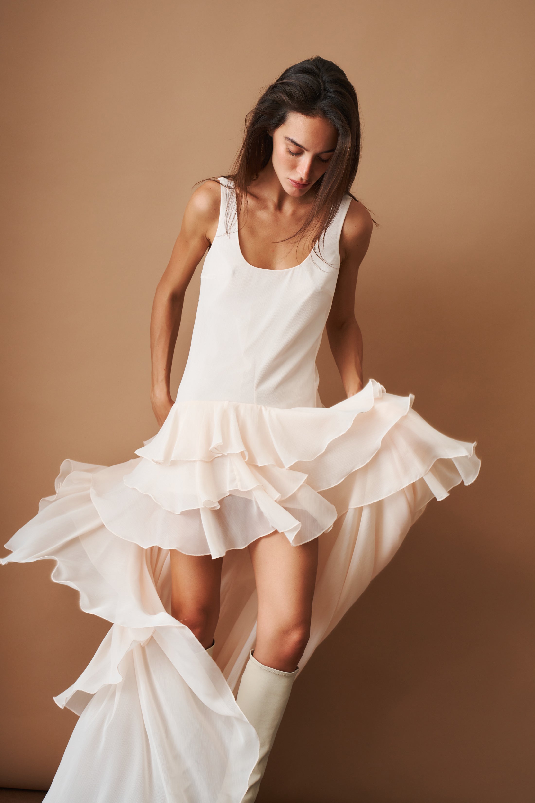 Light blue chiffon ruffle dress by ROTATE, flowing fabric with layered ruffles, perfect for elegant occasions.