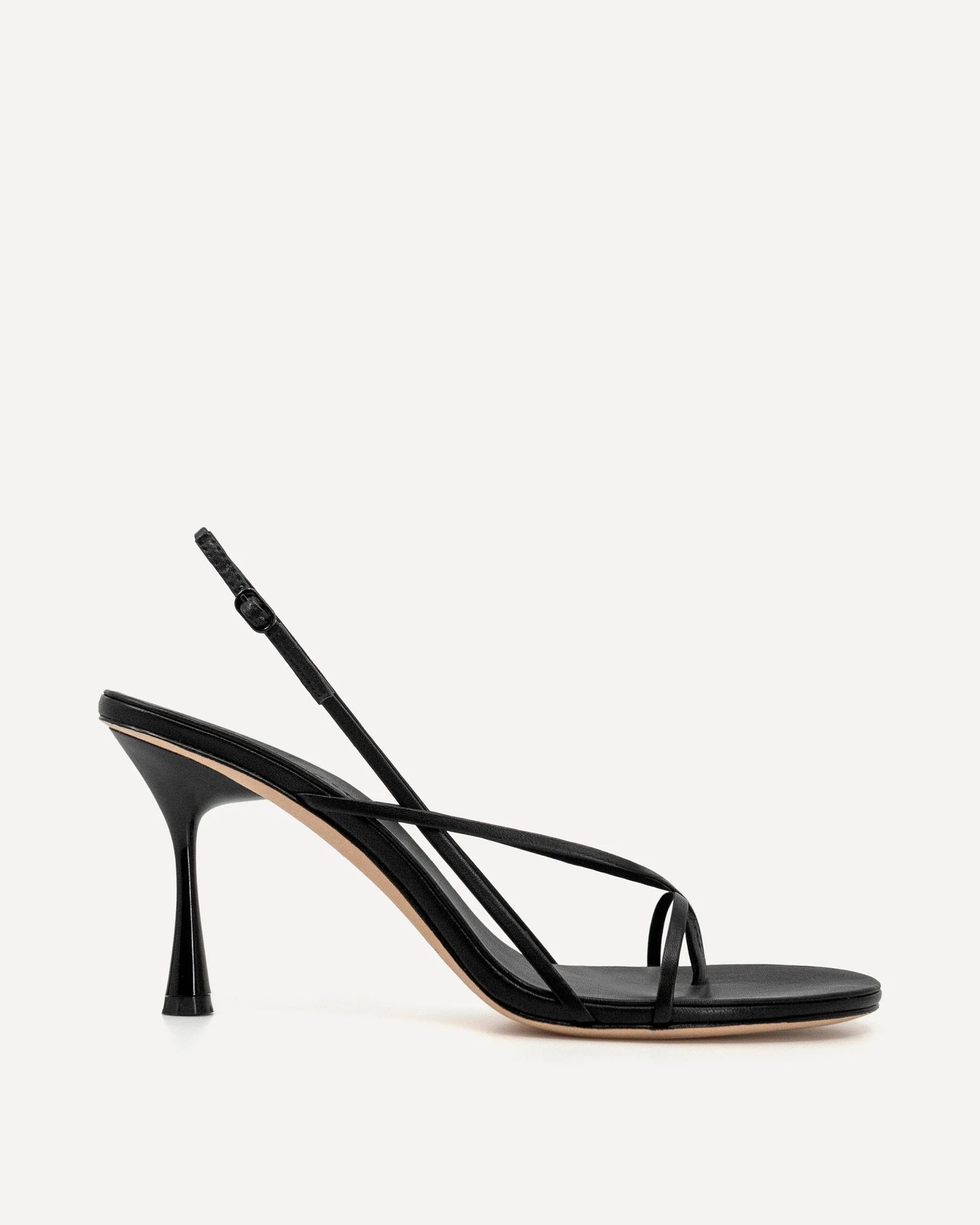 Black Wishbone 90 heel shoes by STUDIO AMELIA featuring a sleek design and pointed toe on a neutral background.
