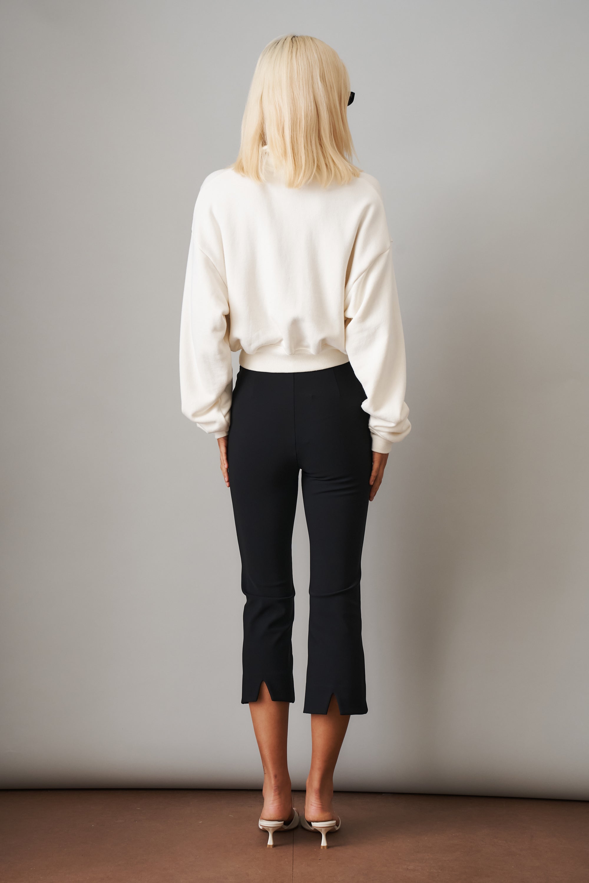 Cream cropped half zip sweatshirt from ETERNE, showing soft fabric, ribbed cuffs, and stylish relaxed fit.