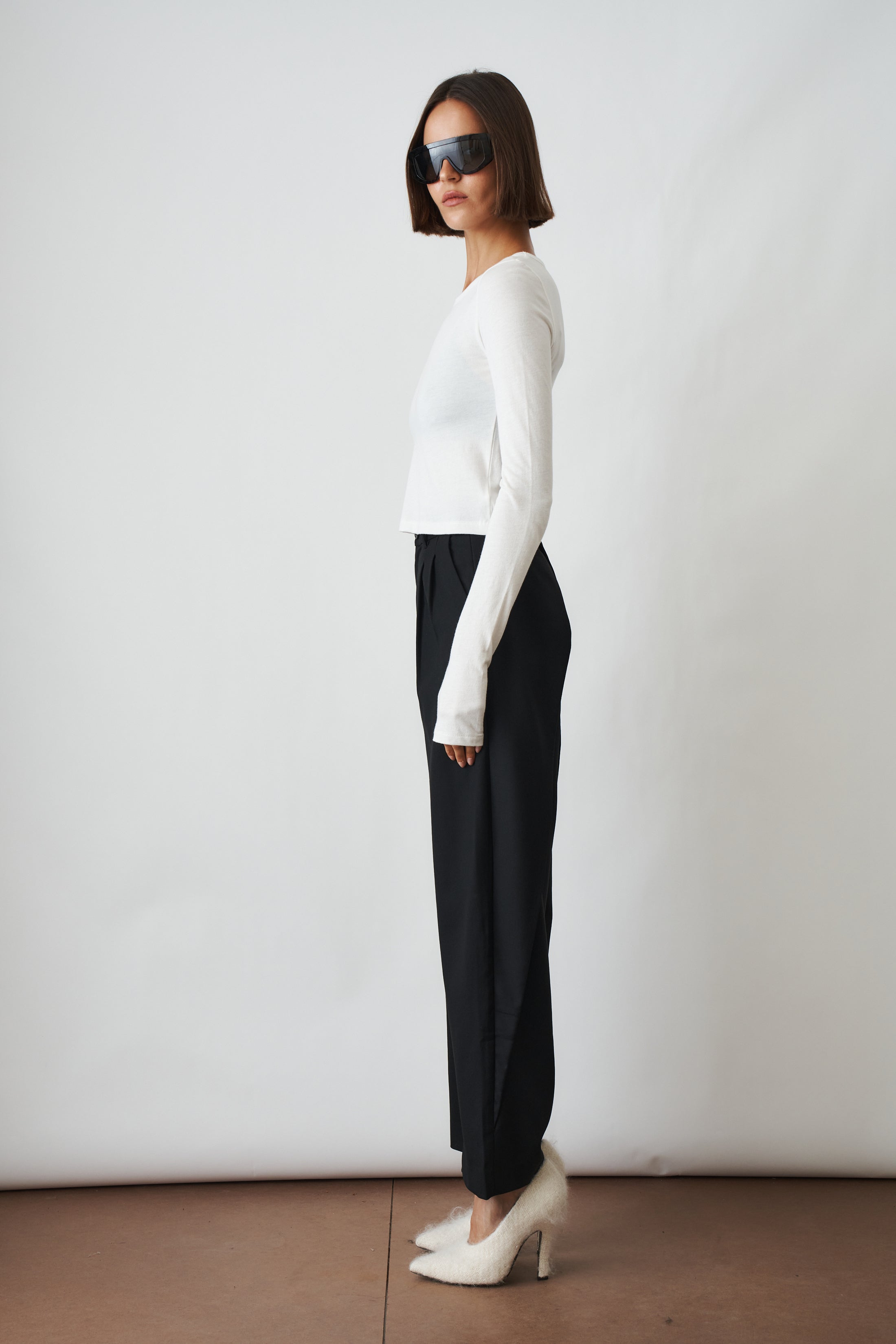 Ivory long sleeve baby tee from ETERNE, soft cotton top for infants with a round neckline and simple design.