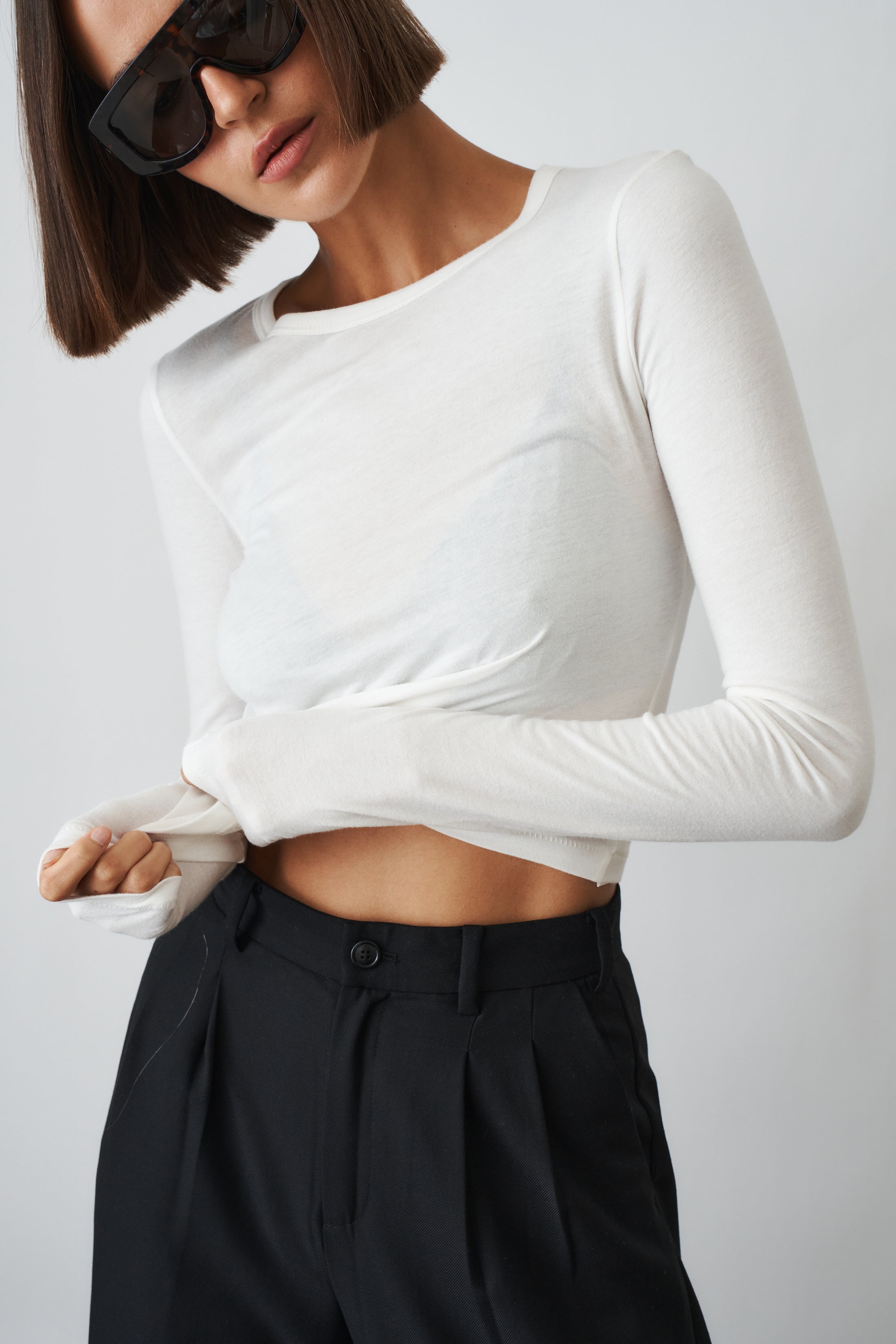 Ivory long sleeve baby tee by ETERNE, soft cotton top for infants with a comfortable fit and simple design.
