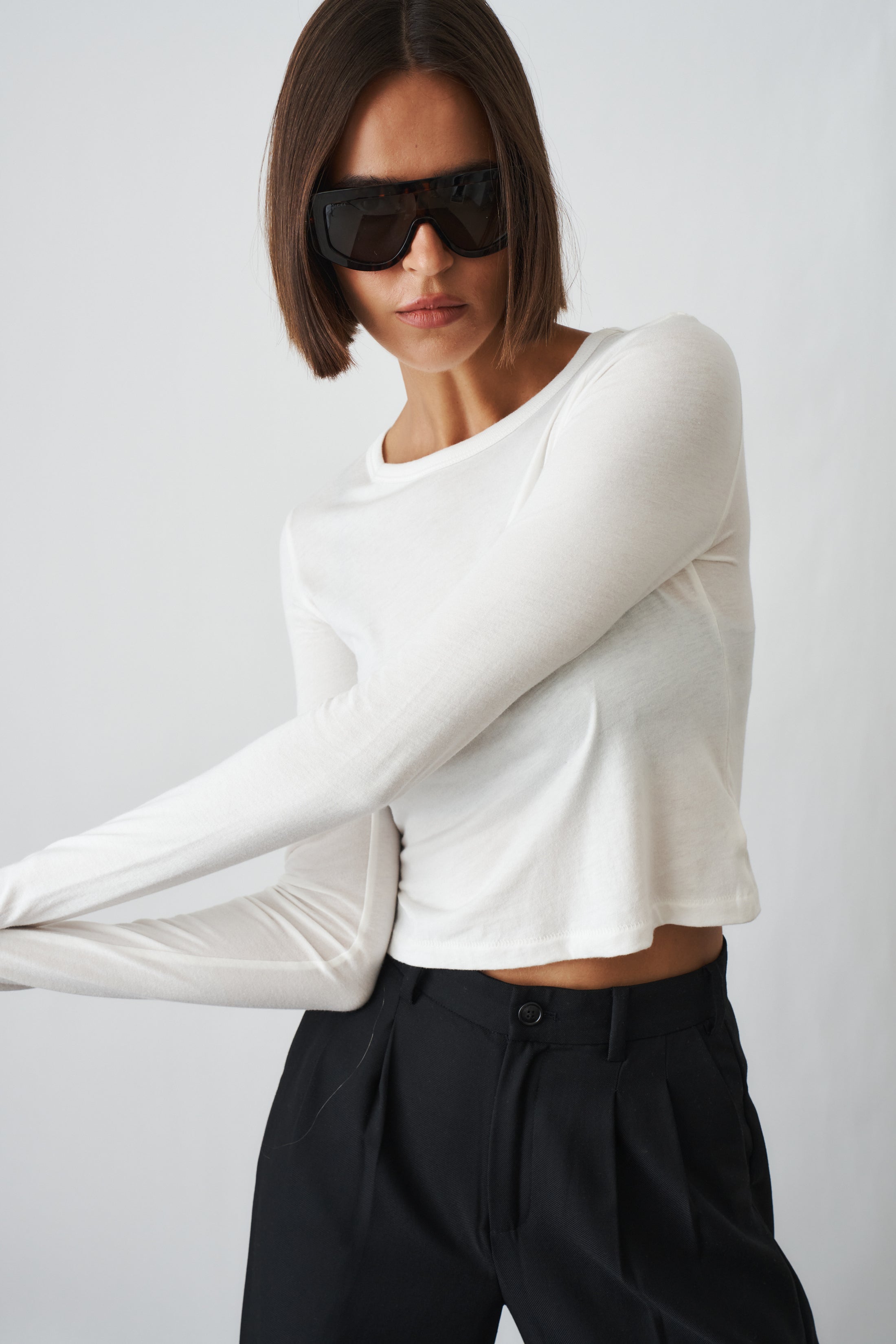 Ivory long sleeve baby tee by ETERNE, soft cotton top for infants, featuring a simple round neckline and comfortable fit.