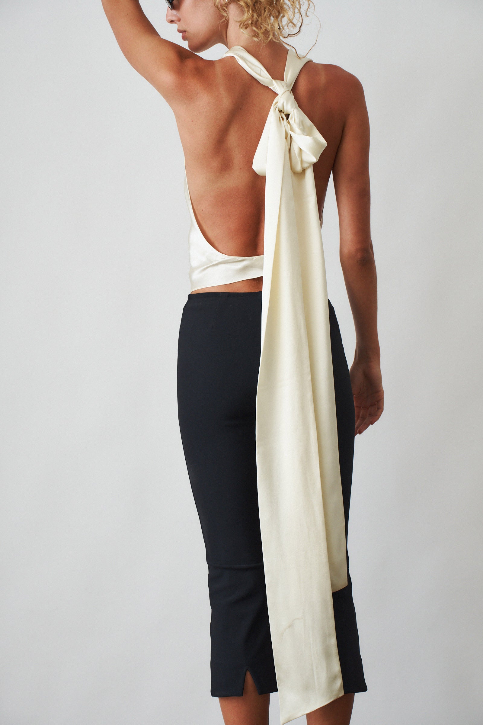 Ivory cowl neck halter top by ORSEUND IRIS, stylish sleeveless blouse with draped neckline and modern design.