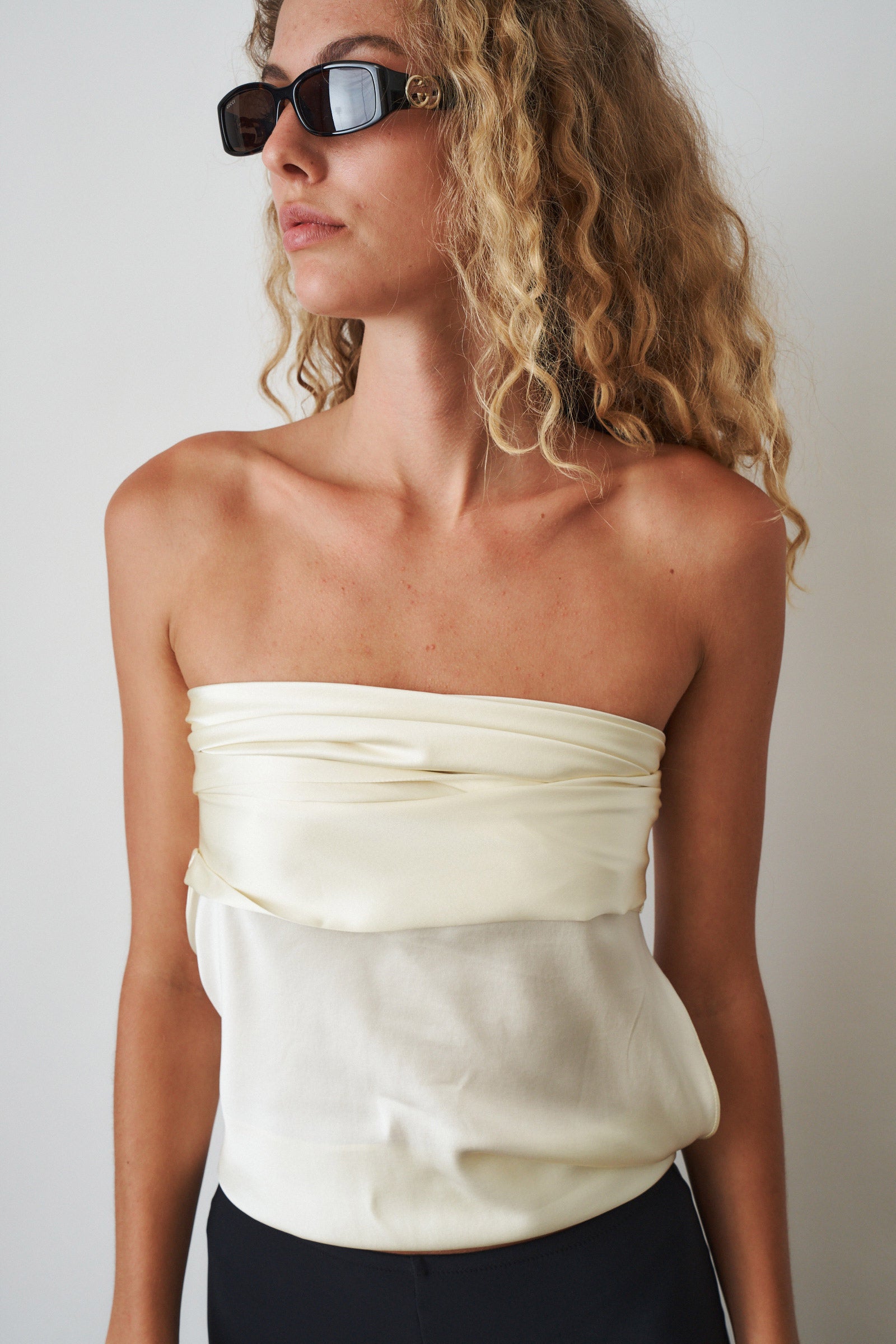 Ivory cowl neck halter top by ORSEUND IRIS, featuring a stylish neckline and sleeveless design, perfect for casual or dressy occasions.