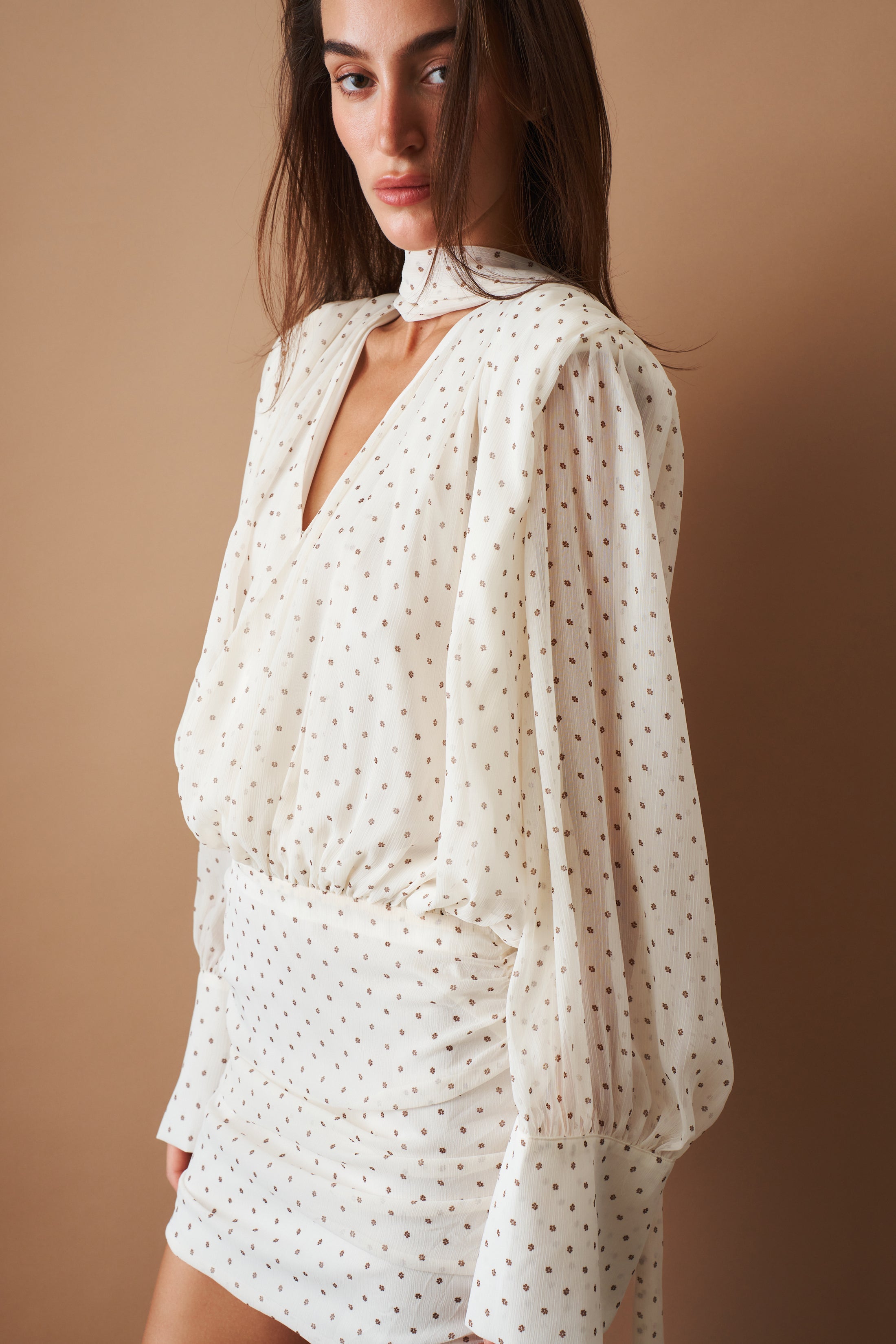Rotate chiffon long sleeve V-neck dress displayed on a model, featuring flowing fabric and elegant design.