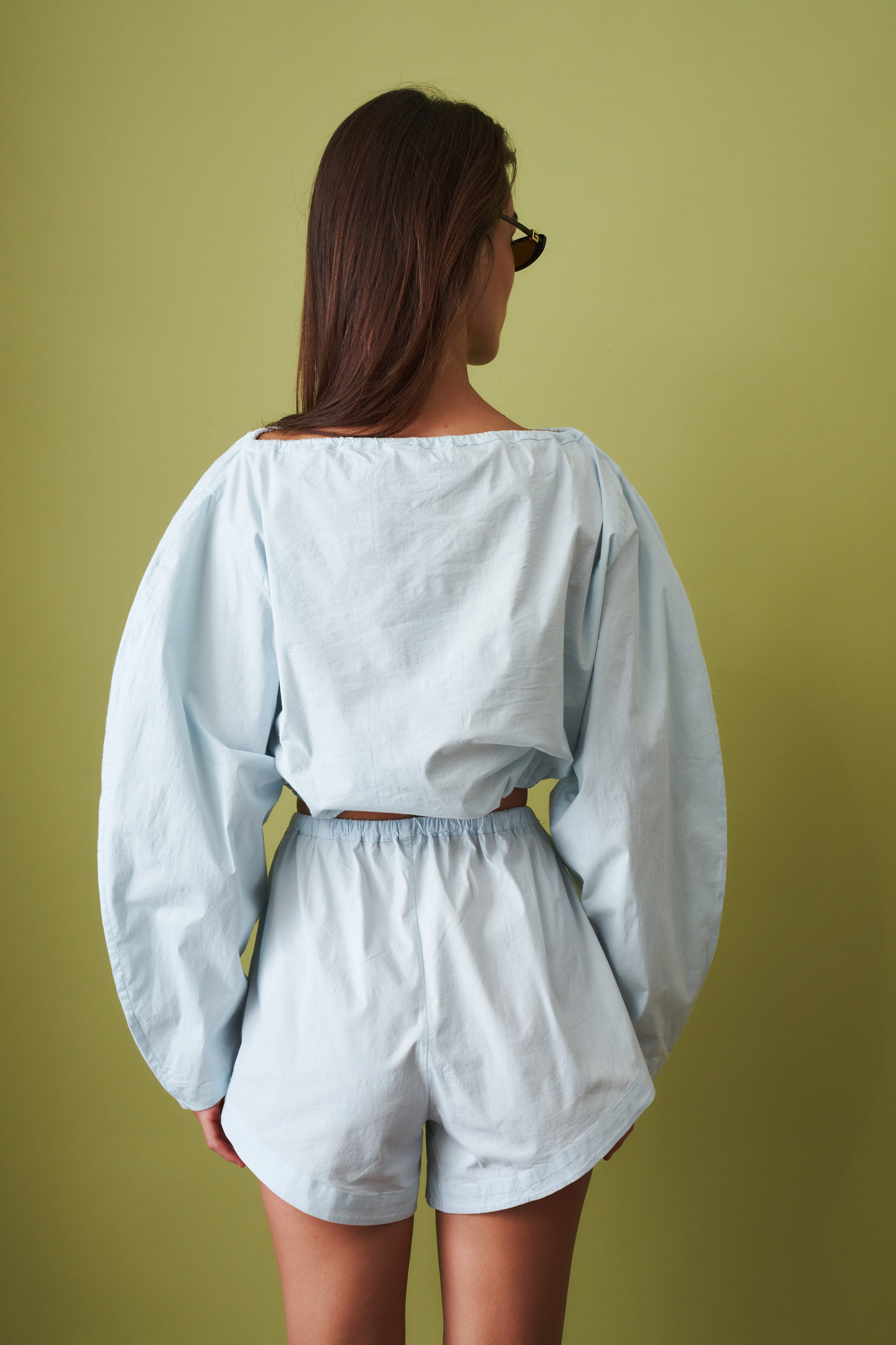 ROTATE drawstring shorts with adjustable waist, lightweight fabric, and casual fit, shown in a relaxed style.