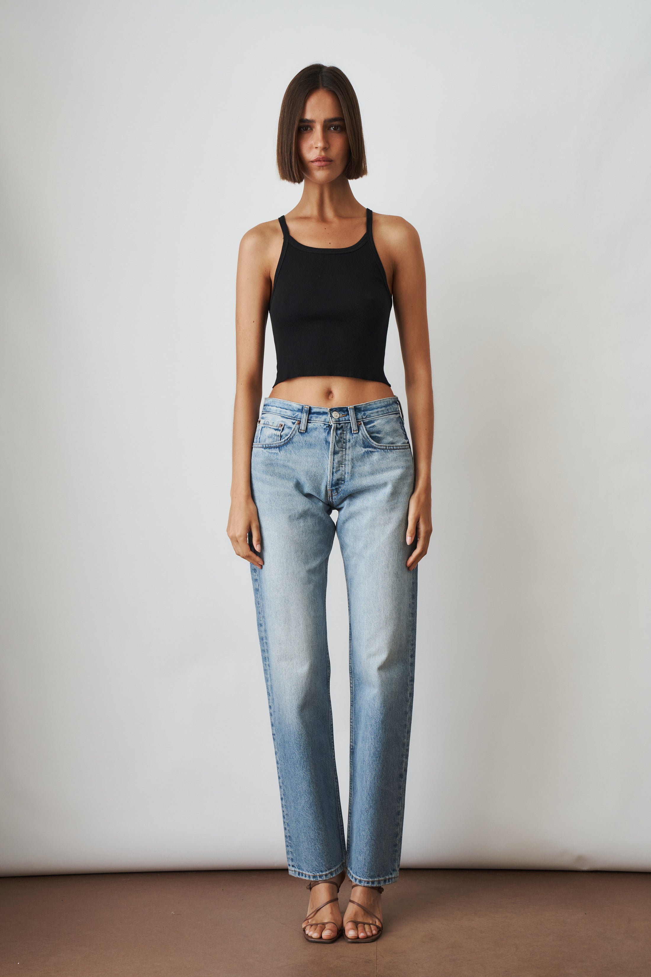 Aya Muse straight jeans in XXS, classic denim pants with a fitted silhouette and front pockets, shown on a model.