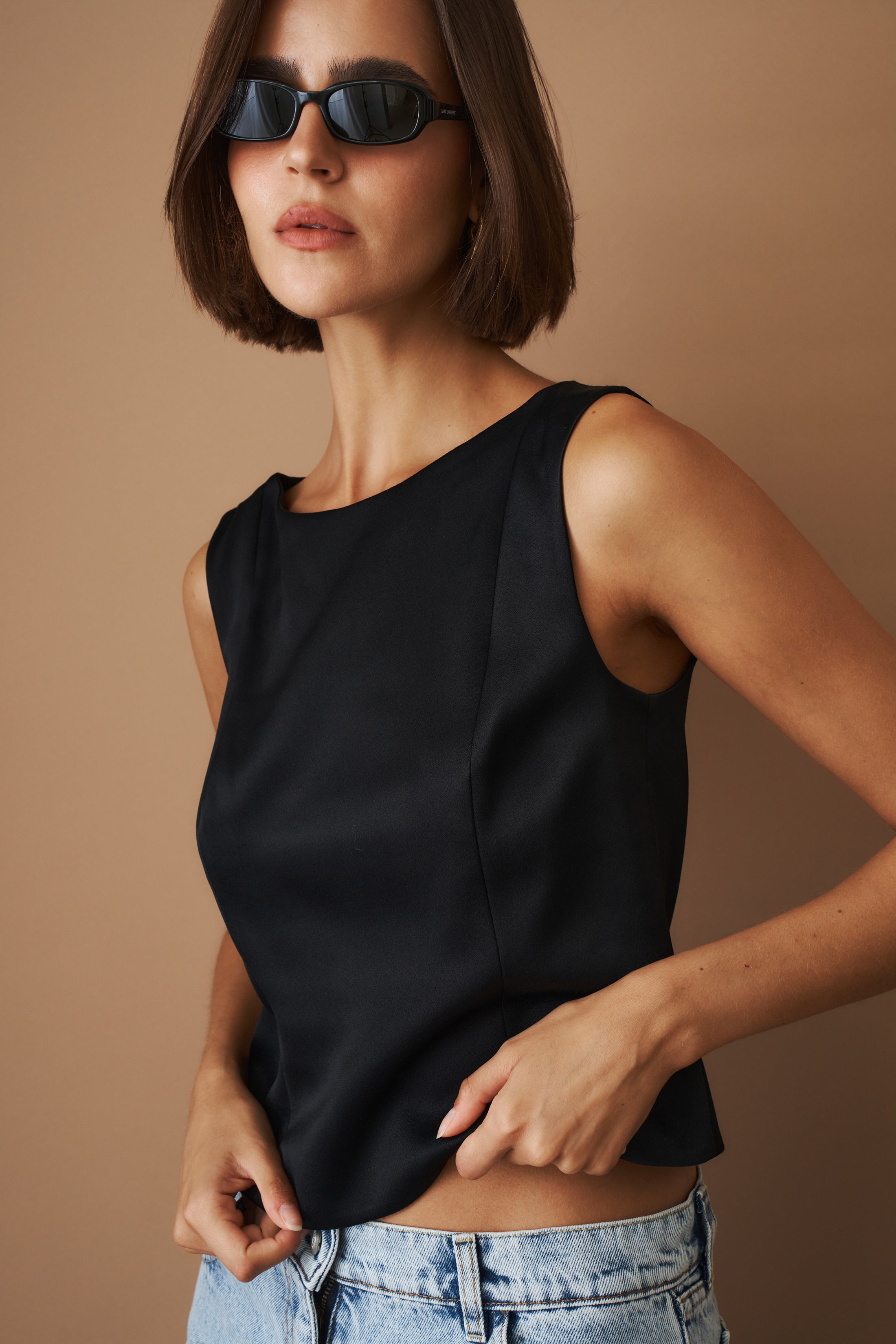 DÉSORDRE Hargrave Top in soft fabric with a relaxed fit, featuring a V-neck and long sleeves, shown on a neutral background.