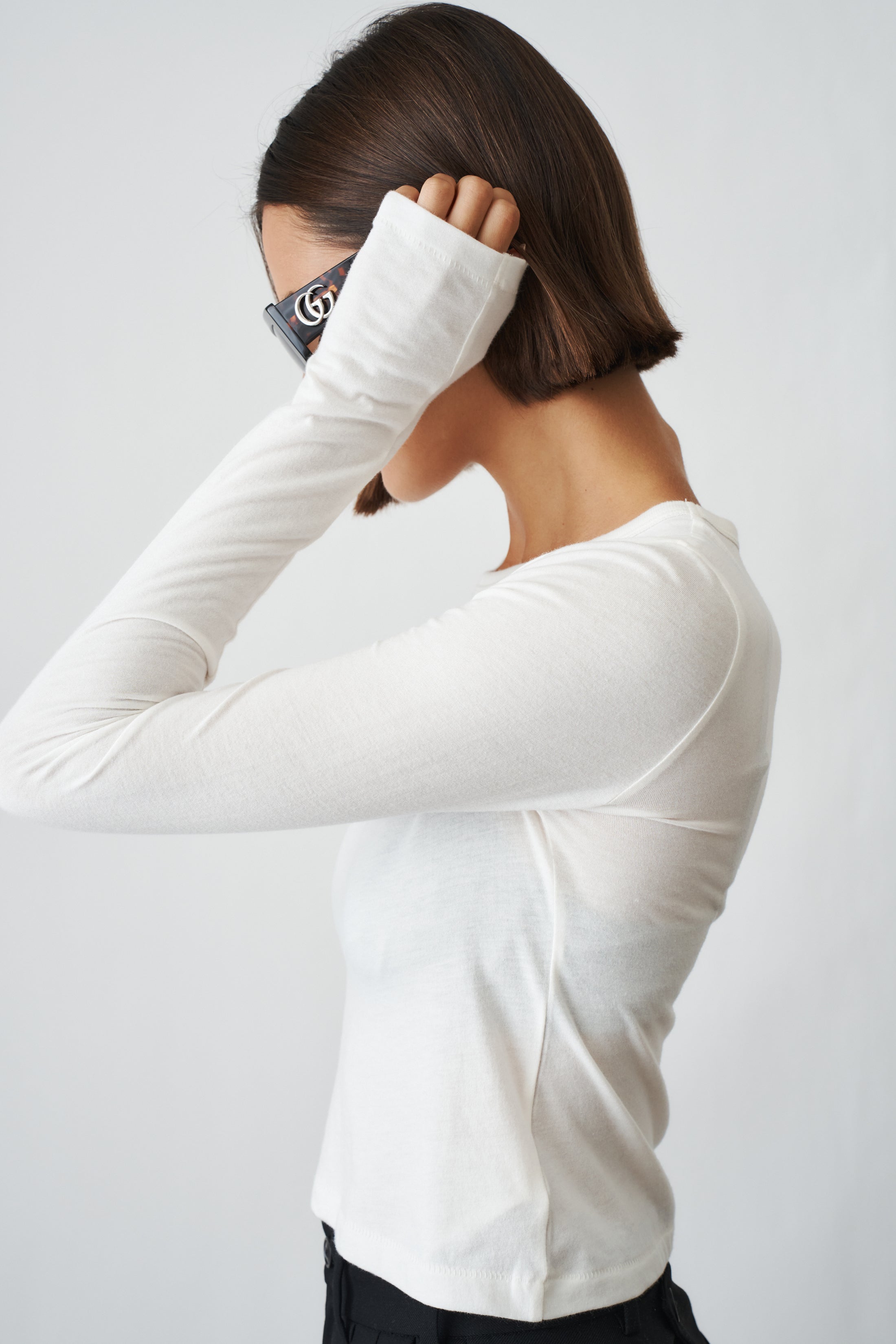 Ivory long sleeve baby tee from ETERNE, soft cotton top for infants with a simple, comfortable design.