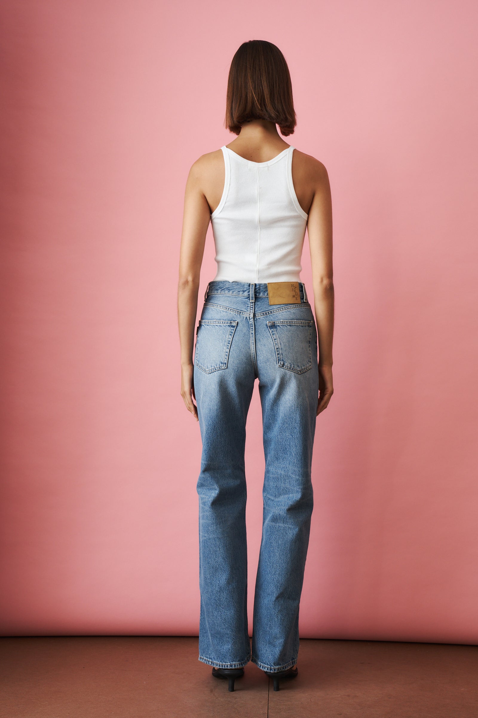 Haikure Korea Nordic Blue jeans displayed on a hanger, showcasing their slim fit and classic denim design.