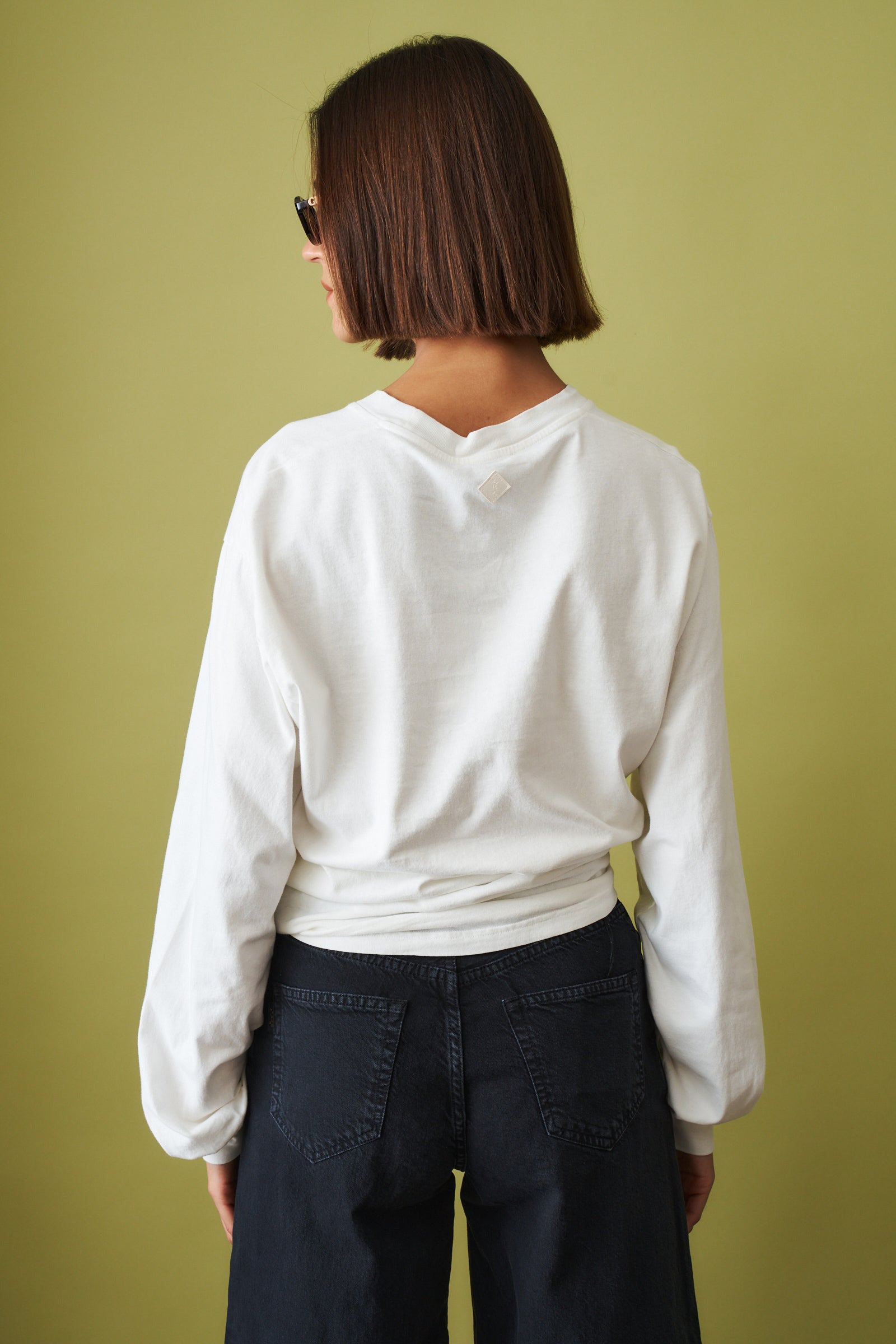 Off-white Ellys T-shirt by Haikure, casual cotton top with a relaxed fit, short sleeves, and round neckline.