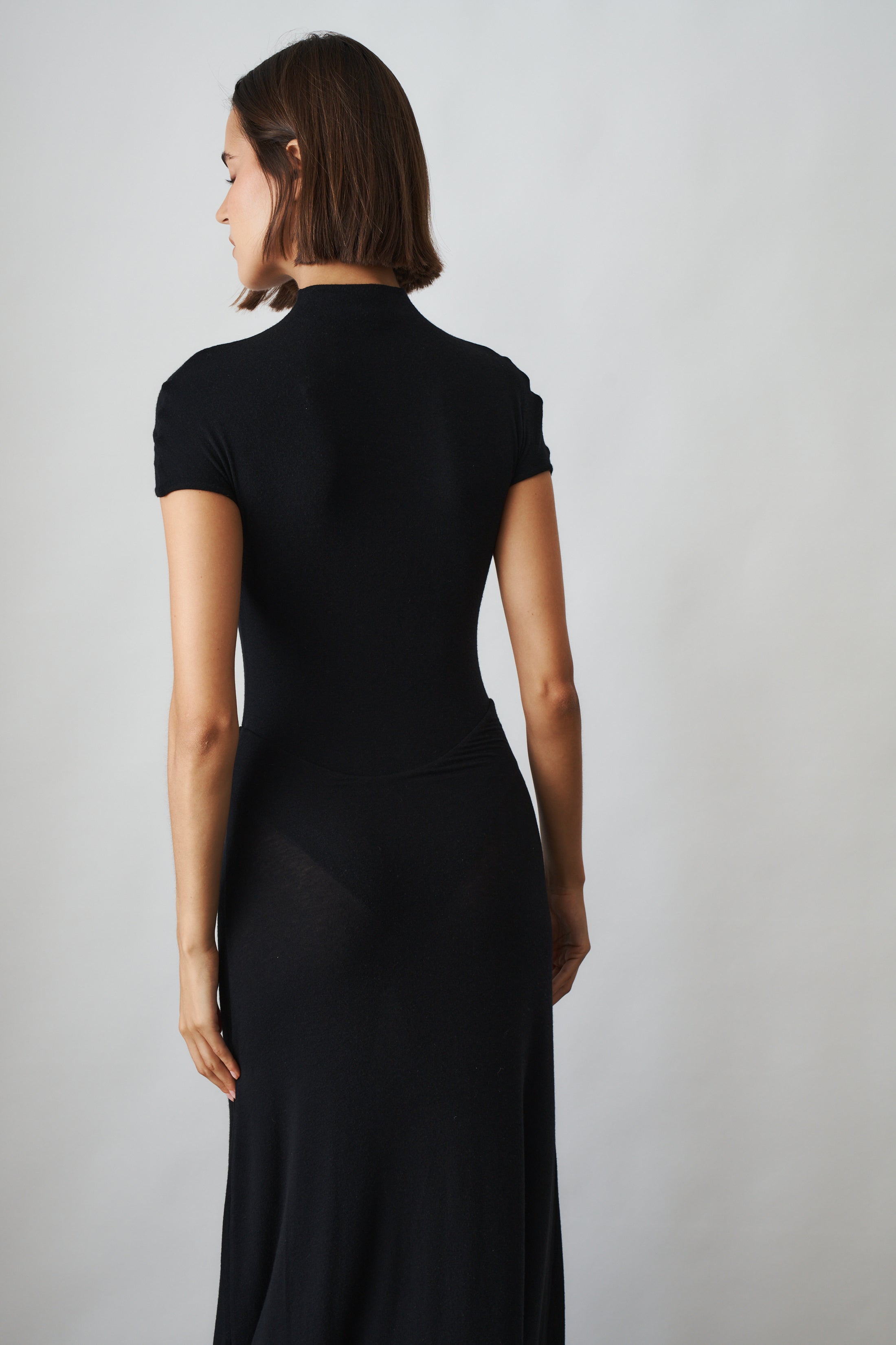Black Mia Dress by MANURI, stylish sleeveless dress with a fitted silhouette and elegant design, shown on a model.