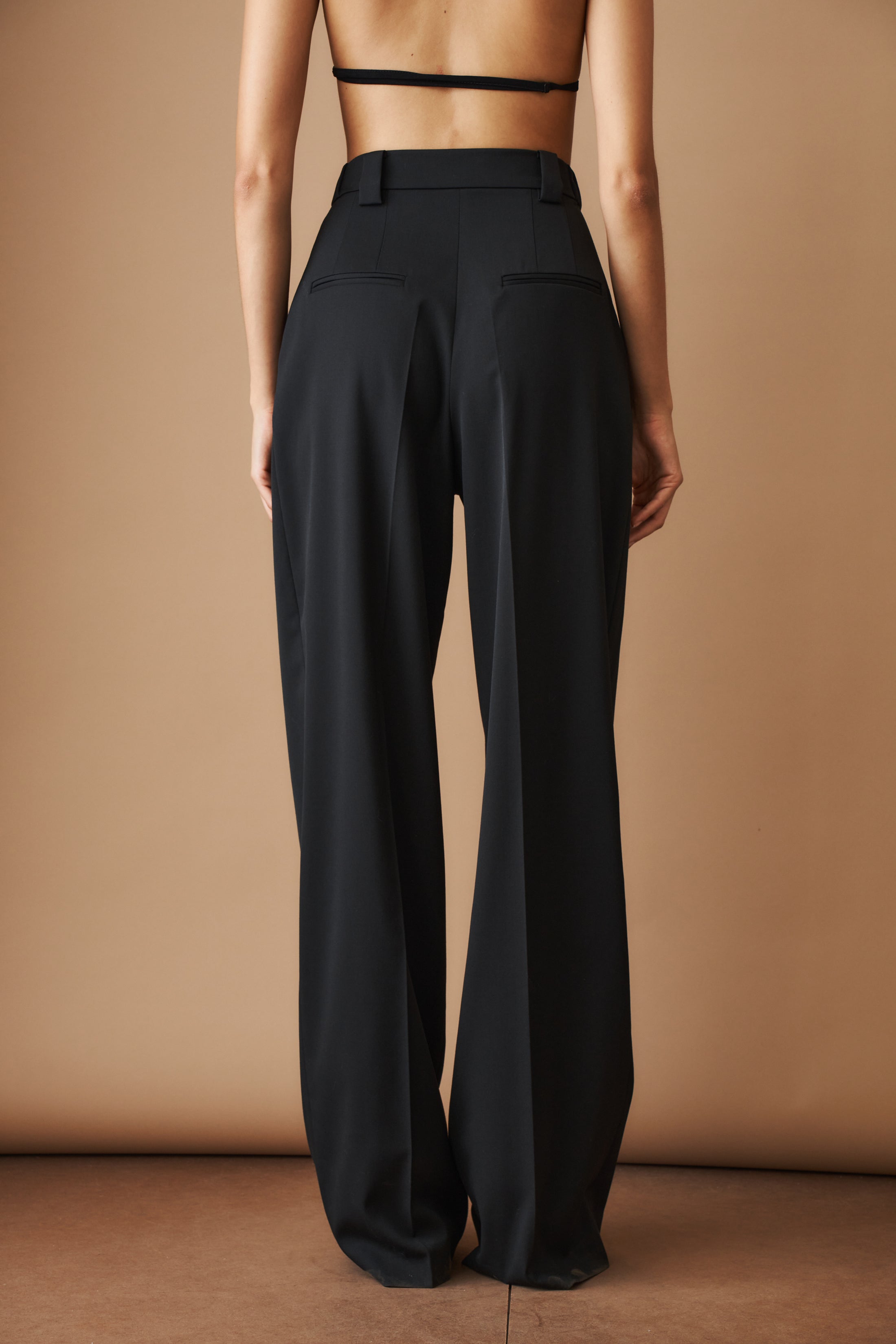 Black wool pants by MOMS PANTS, featuring a tailored fit and classic design, displayed on a neutral background.