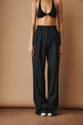 Black wool pants from MOMS PANTS, featuring a comfortable fit, shown on a model with a relaxed, stylish look.