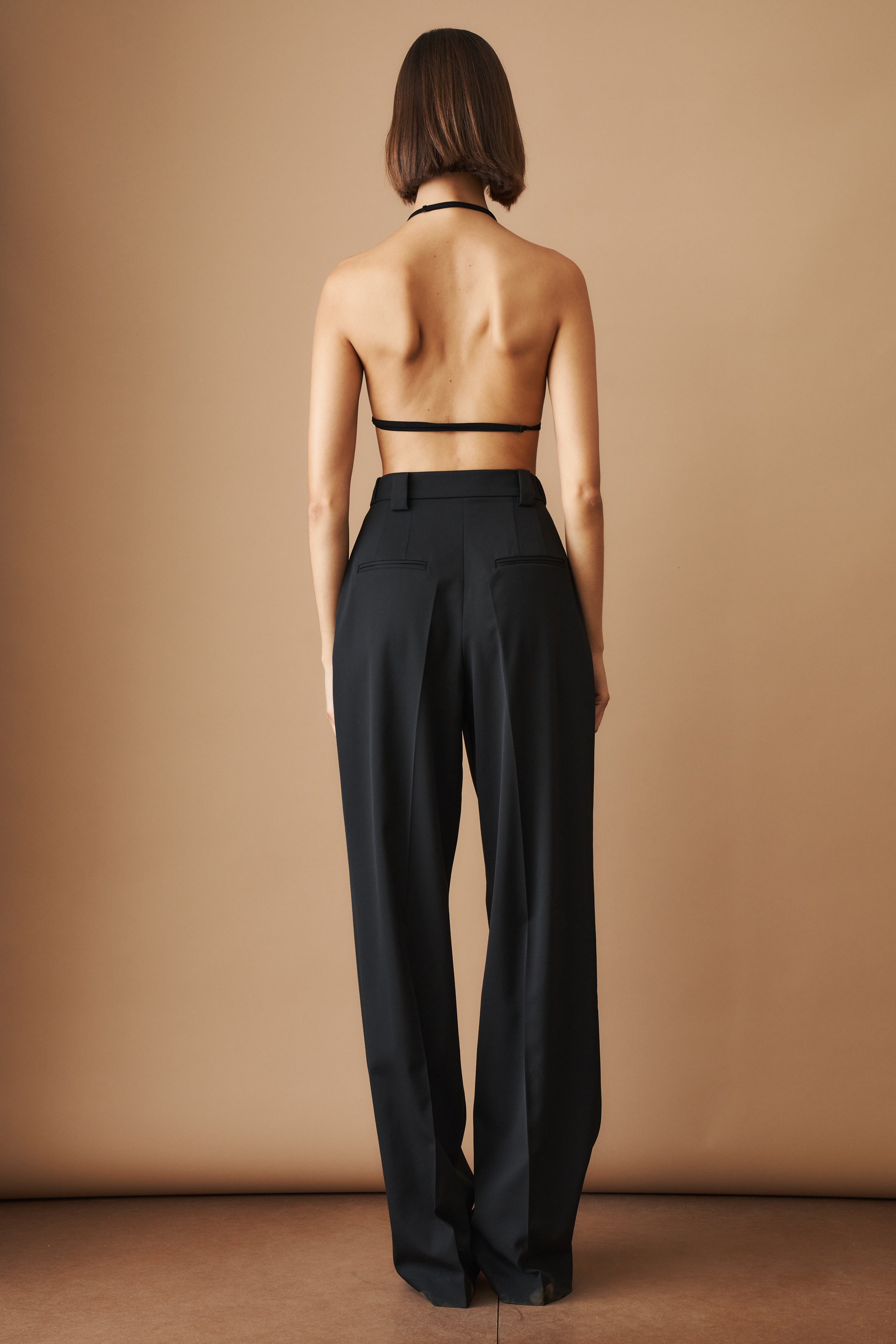 Black wool pants by MOMS PANTS, featuring a tailored fit and classic style, shown on a model.