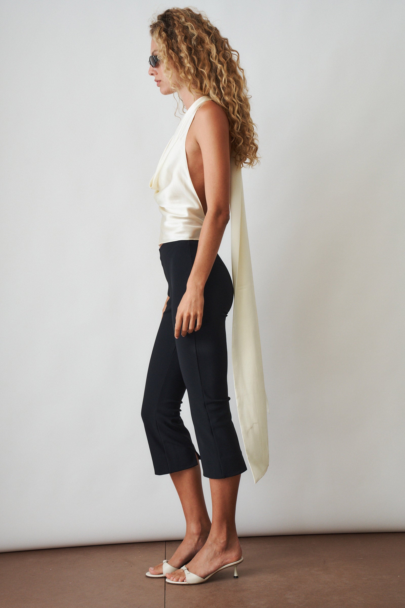Ivory cowl neck halter top from ORSEUND IRIS, featuring a stylish, flowing neckline and sleeveless design.