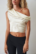 Ivory cowl neck halter top by ORSEUND IRIS, featuring a stylish neckline and sleeveless design, perfect for casual or dressy occasions.