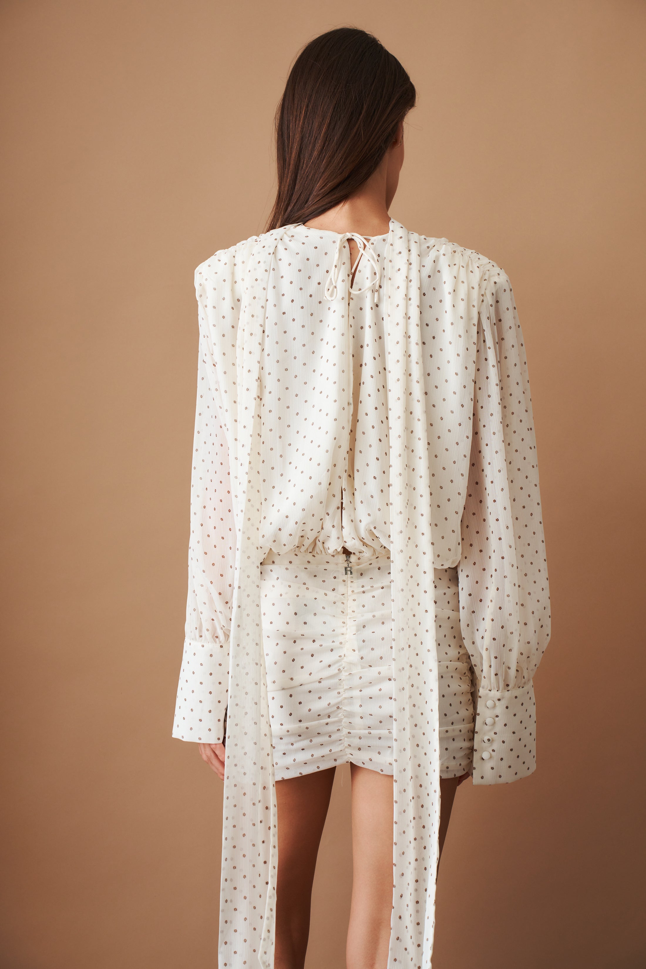 Rotate chiffon long sleeve V-neck dress displayed on a hanger, featuring flowy fabric and elegant design.